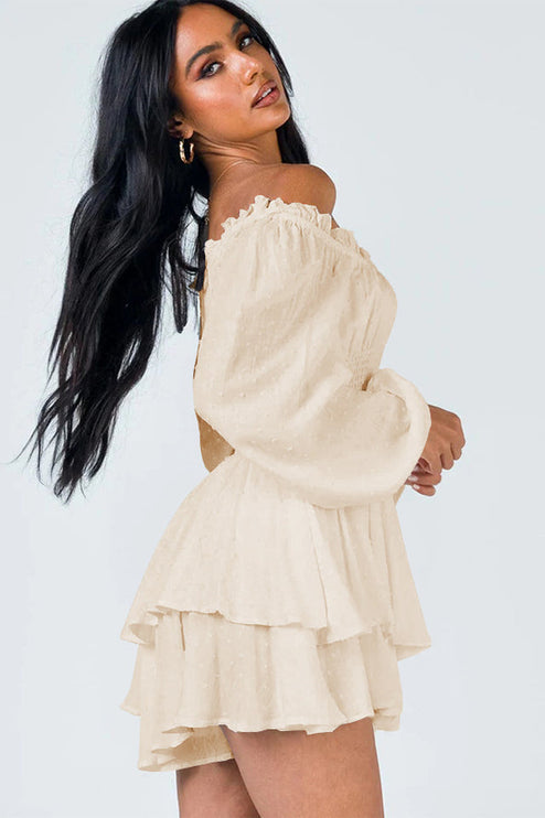 Side profile of a women's cream off-shoulder mini dress, highlighting the long balloon sleeves and ruffled hem.