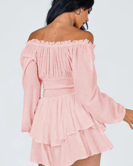 Back view of a women's light pink off-shoulder mini dress featuring long sleeves, shirred waist, and ruffled skirt