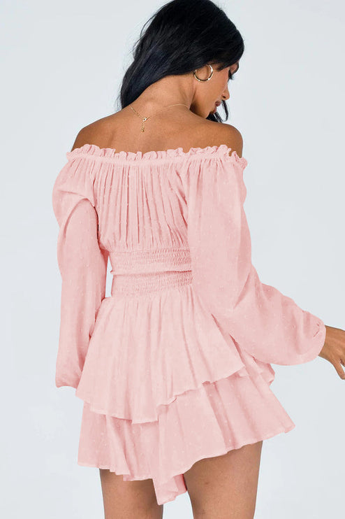 Back view of a women's light pink off-shoulder mini dress featuring long sleeves, shirred waist, and ruffled skirt