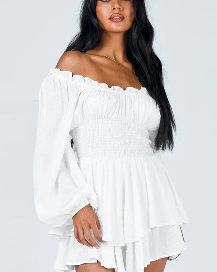 White off-shoulder mini dress with long balloon sleeves and smocked waist, featuring subtle textured dots and ruffled hem.