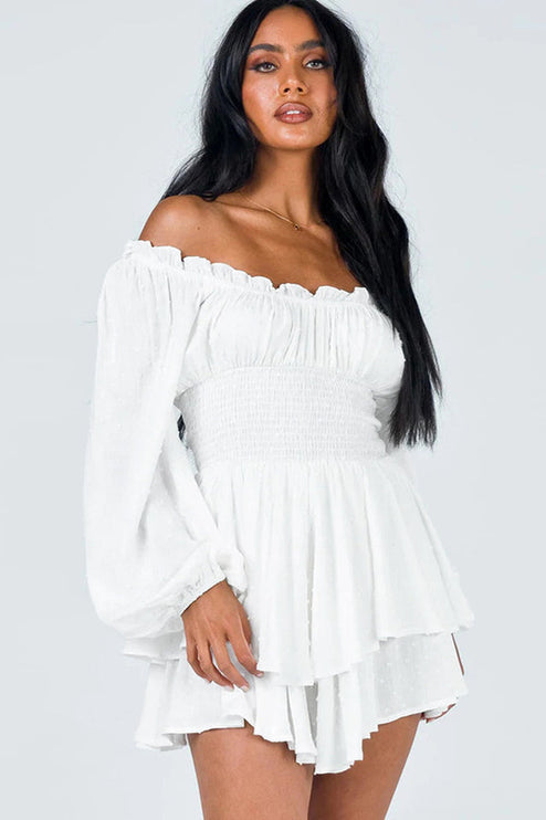 White off-shoulder mini dress with long balloon sleeves and smocked waist, featuring subtle textured dots and ruffled hem.