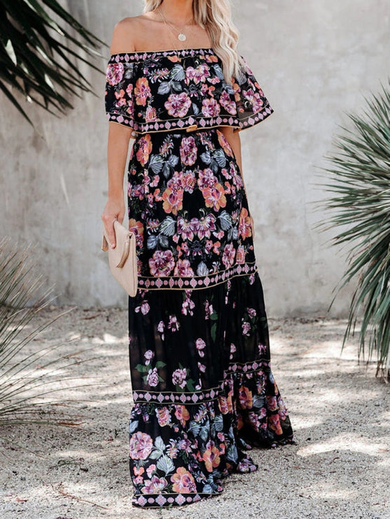 Black women's floral off-shoulder maxi dress with pink and purple blooms, tiered ruffled skirt, and gold accents.