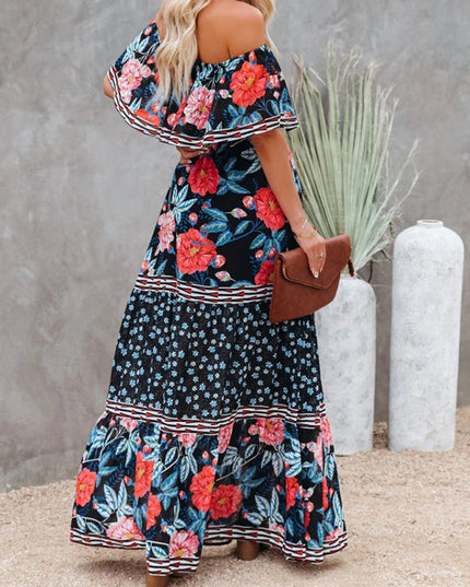 Back view of a women's black floral off-shoulder maxi dress, showing the ruffled neckline and tiered skirt design.