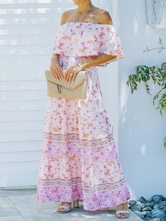Front view of a light pink floral off-shoulder ruffled maxi dress with a tiered skirt and intricate patterns.