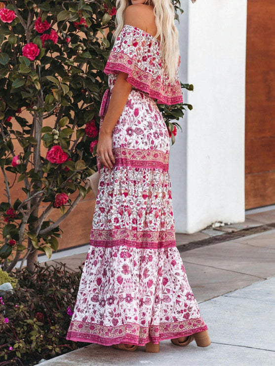 Back view of white and fuchsia floral off-shoulder ruffled maxi dress, highlighting the flowy fabric and tiered design.