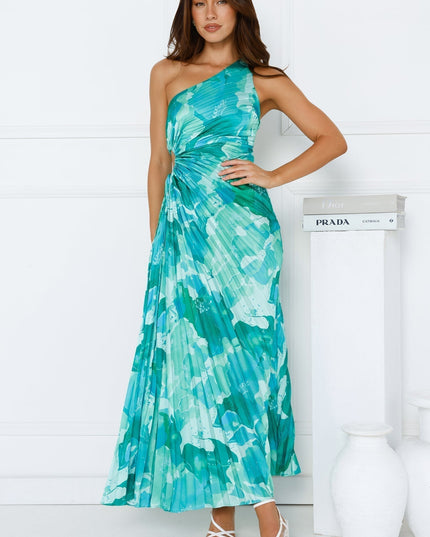 Full length view of a women's blue and green floral one shoulder maxi dress with a side cutout and pleated skirt.
