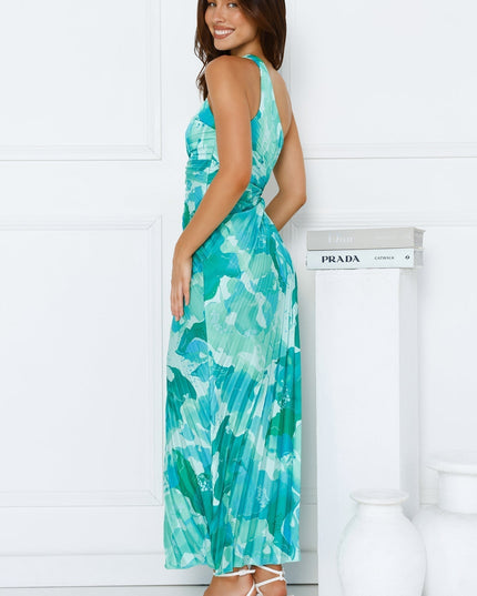 Side profile of the women's blue and green floral one shoulder pleated maxi dress, highlighting the fitted bodice and flowing skirt.