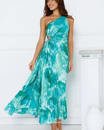 Women's one shoulder cutout pleated maxi dress in a vibrant blue and green floral pattern, flowing gracefully.