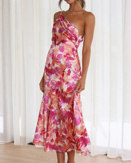 Front view of women's floral one-shoulder midi dress, vibrant pink and orange floral pattern, flowing skirt.