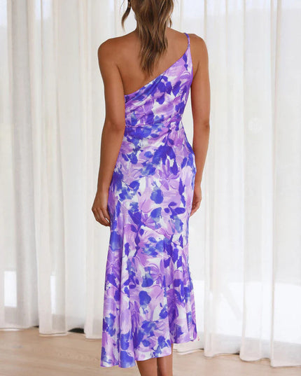 Back view of women's floral one shoulder midi dress in purple and blue with ruched bust detail.