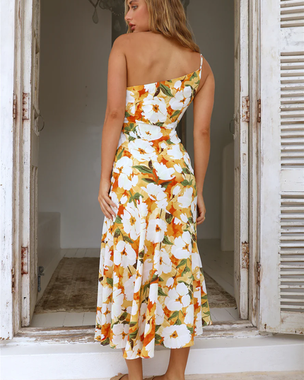 Back view of women's floral one-shoulder midi dress, white with orange and green flowers, showing strap detail.