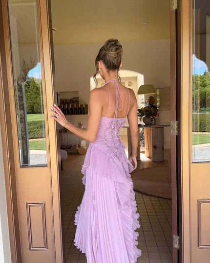 Back view of the women's lavender one-shoulder midi dress, showcasing the delicate spaghetti straps and pleated skirt.