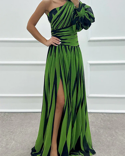Women's green and black striped one-shoulder maxi dress, showcasing the high slit and puff sleeve
