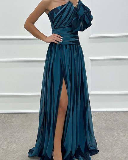Women's teal and black striped one-shoulder maxi dress, highlighting the high slit and elegant design