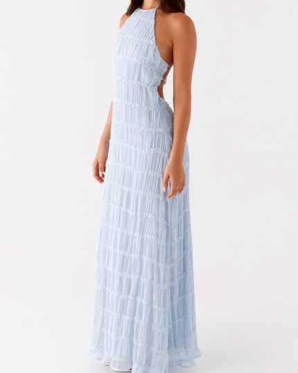 Light blue halter neck maxi dress with open back and ruched texture, for prom or formal events.