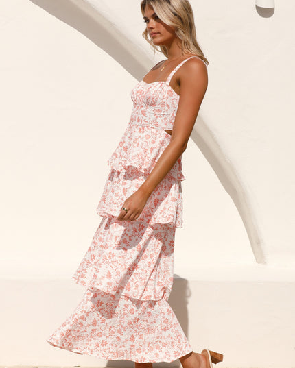 Side profile of a woman wearing the pink floral ruffled maxi dress, showing movement and flow of the tiered skirt.
