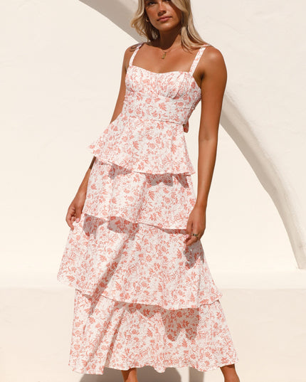 Side profile of a women's pink floral ruffled maxi dress with tiered skirt, ideal for a wedding guest.