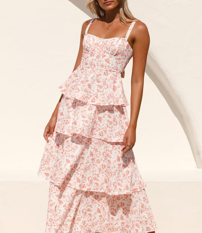 Side profile of a women's pink floral ruffled maxi dress with tiered skirt, ideal for a wedding guest.