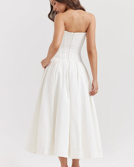Back view of a white strapless boned bodice pleated midi dress, with a visible zipper closure.