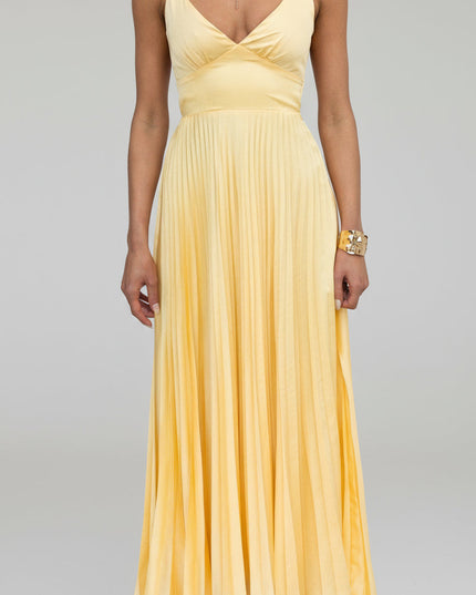Close-up front view of a yellow V-neck pleated maxi dress, showcasing the bodice and skirt pleats.