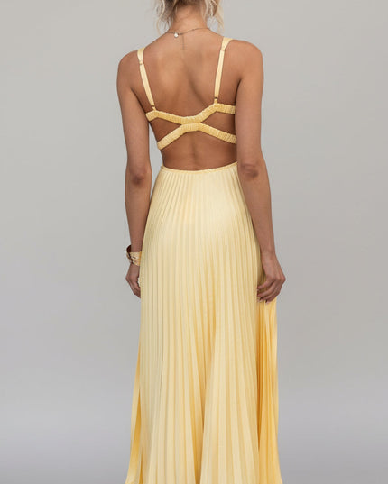 Full back view of the yellow V-neck pleated maxi dress, detailing the open back and criss-cross straps.