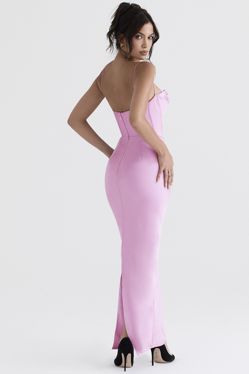 Back view of a women's pink satin corset plunge neck maxi dress, the sleek fit and a back slit, with black high heels.