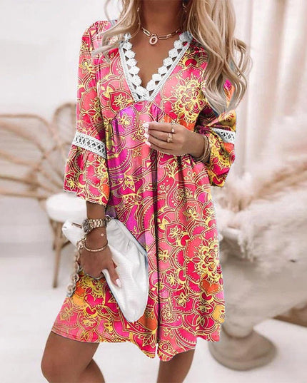 Women's summer mini dress in a bright pink and orange intricate floral pattern, V-neck, and lace trim.
