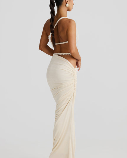 Back view of the women's off-white maxi skirt set, showing the twisted rope straps and ruched detailing on the back of the skirt.
