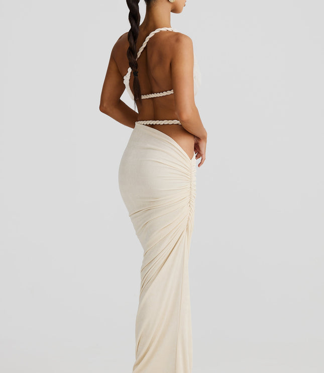 Back view of the women's off-white maxi skirt set, showing the twisted rope straps and ruched detailing on the back of the skirt.