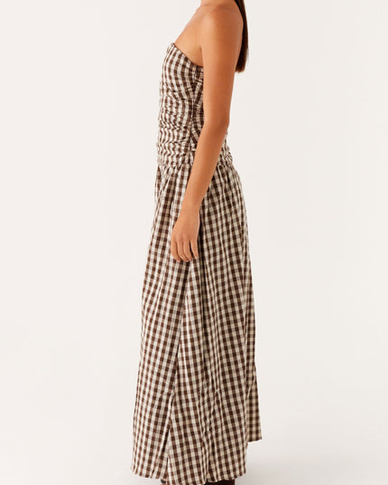 Profile view of women's brown and white gingham strapless maxi dress, ruched detail