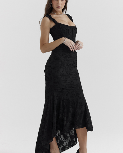 Side view of a women's black floral ruched maxi dress, highlighting the elegant silhouette and high-low hem.