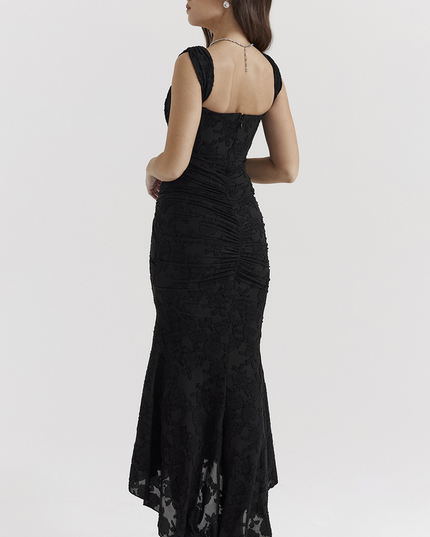 Back view of the black floral ruched off-shoulder maxi dress, showcasing the ruched detailing and elegant high-low hemline.