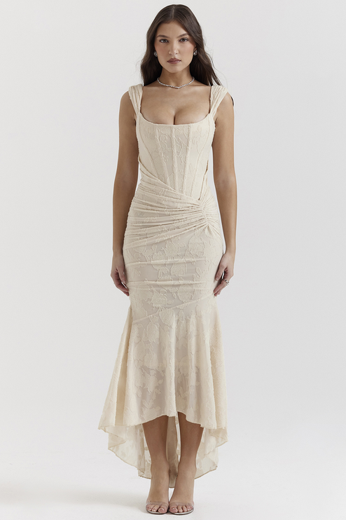 Front view of a cream floral ruched maxi dress with structured shoulder straps and a mermaid silhouette.