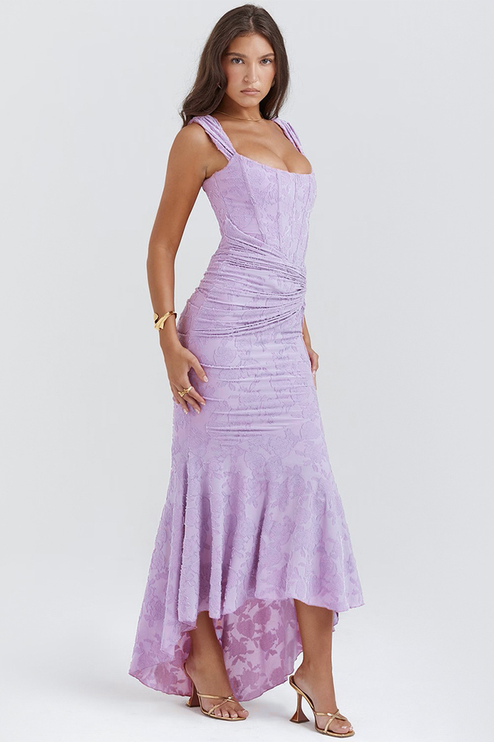 Side profile of the light purple floral ruched off-shoulder maxi dress, showcasing the elegant fit and flare high-low silhouette.