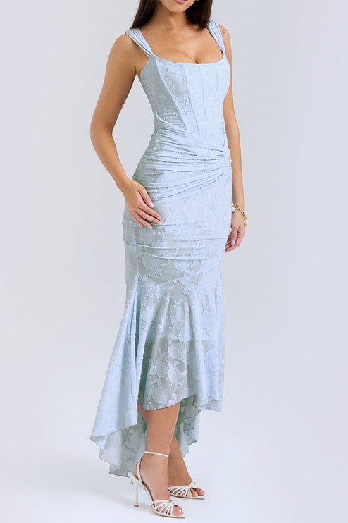 Side profile of the women's light blue floral ruched maxi dress, showing the elegant drape and high-low skirt with white heels.