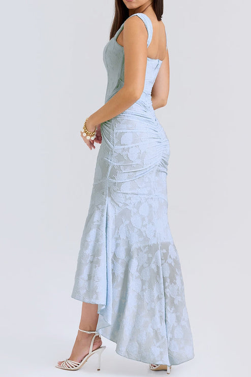 Three-quarter back view of the women's light blue floral ruched maxi dress, highlighting the fitted bodice and flowing skirt.