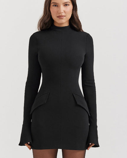 Black mock neck long sleeve mini dress featuring ruffle cuffs and front flap pockets, full frontal view.