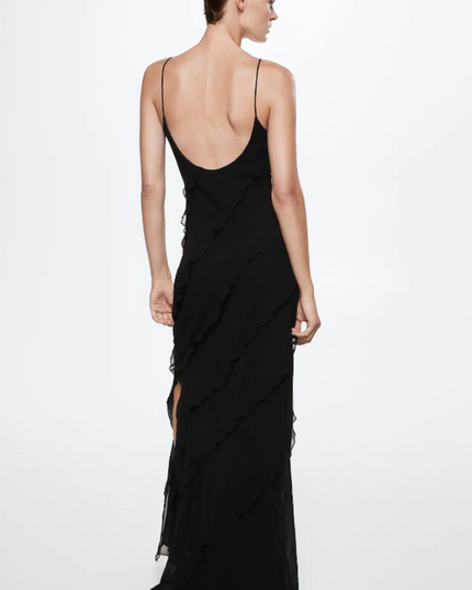 Back view of a black V-neck ruffle side slit maxi dress with a low back and flowing ruffles