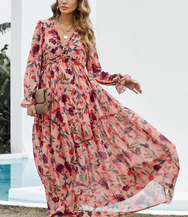 Women's flowing pink floral print maxi dress with long sleeves, ruffle details, and a V-neckline.