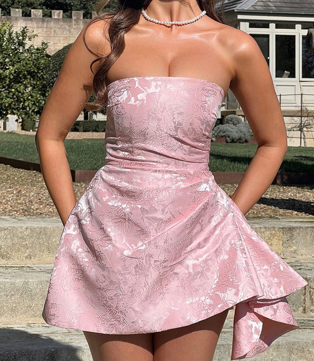 Full front view of a women's strapless pink floral jacquard mini dress with a subtle ruffled hem, for wedding guests.