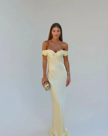 Front view of a women's elegant light yellow satin maxi dress with off-shoulder sleeves and a fitted bodice, ideal for special occasions.