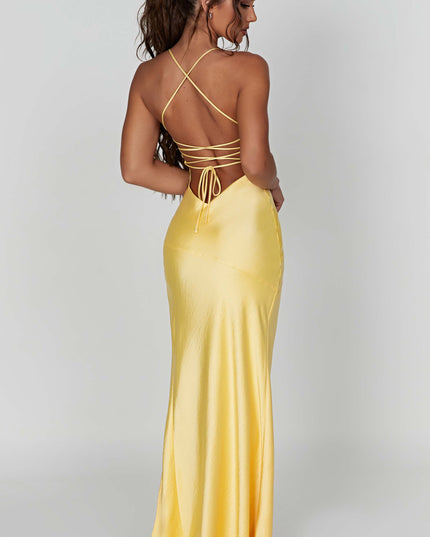 Back view of the yellow satin maxi dress, highlighting the tie-back detail and the smooth, flowing fabric.