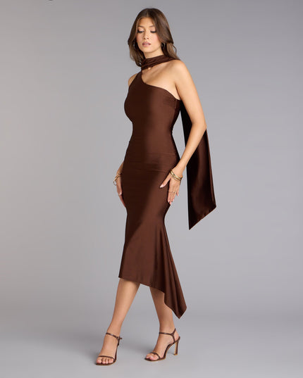 Elegant women's one-shoulder satin midi dress in dark brown with a flowing scarf detail and asymmetric hem.