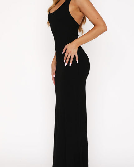 Side profile of the black halter scoop neck maxi dress, highlighting the elegant drape and form-fitting style.
