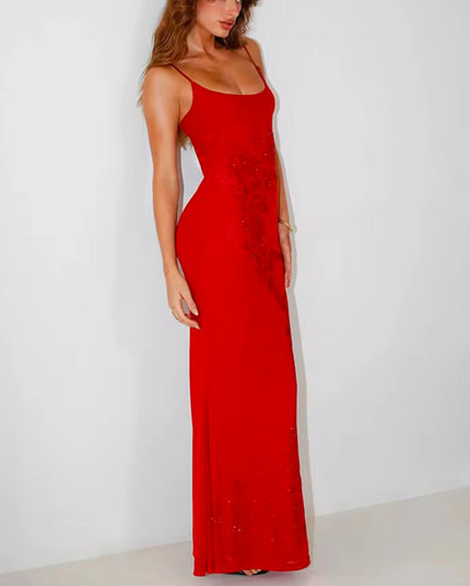 Angled view of the red embellished scoop neck maxi dress, emphasizing the fitted waist and flowing skirt.