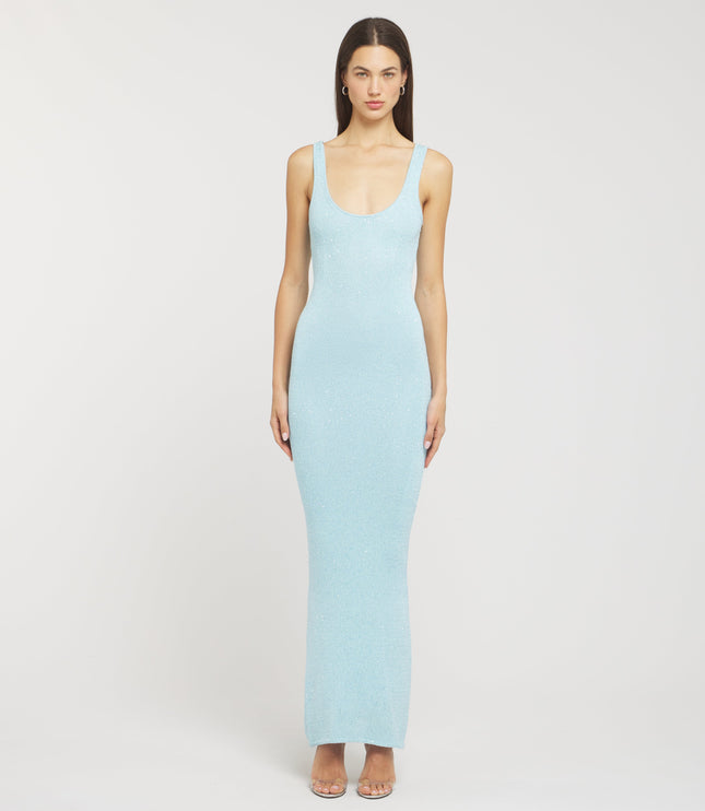 Front view of a light blue sleeveless scoop neck sequin maxi dress, form-fitting, with a subtle shimmer, paired with silver heels.