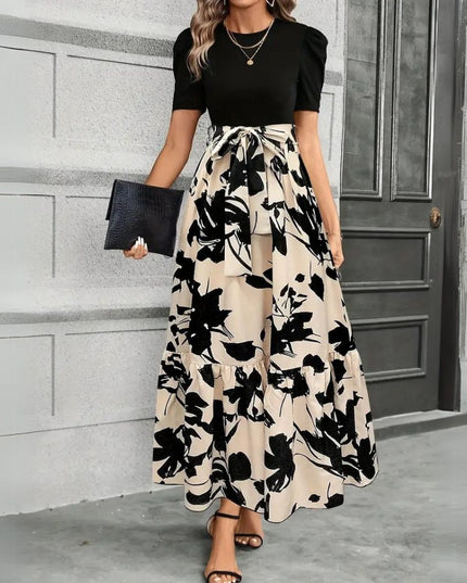Women's black short sleeve top with a high waist maxi dress featuring a large black floral print on a beige background, tied at the waist.
