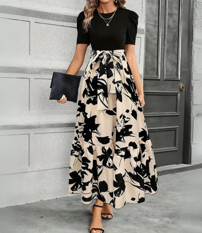 Women's black short sleeve top with a high waist maxi dress featuring a large black floral print on a beige background, tied at the waist.