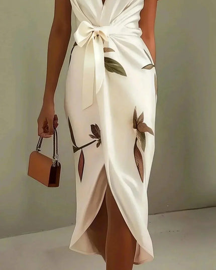 Side view of a women's white leaf print v-neck short sleeve midi wrap dress, showcasing the flowy skirt and purse.