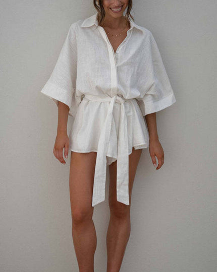 Full front view of a women's white summer collared short romper with wide sleeves and a self-tie waist.
